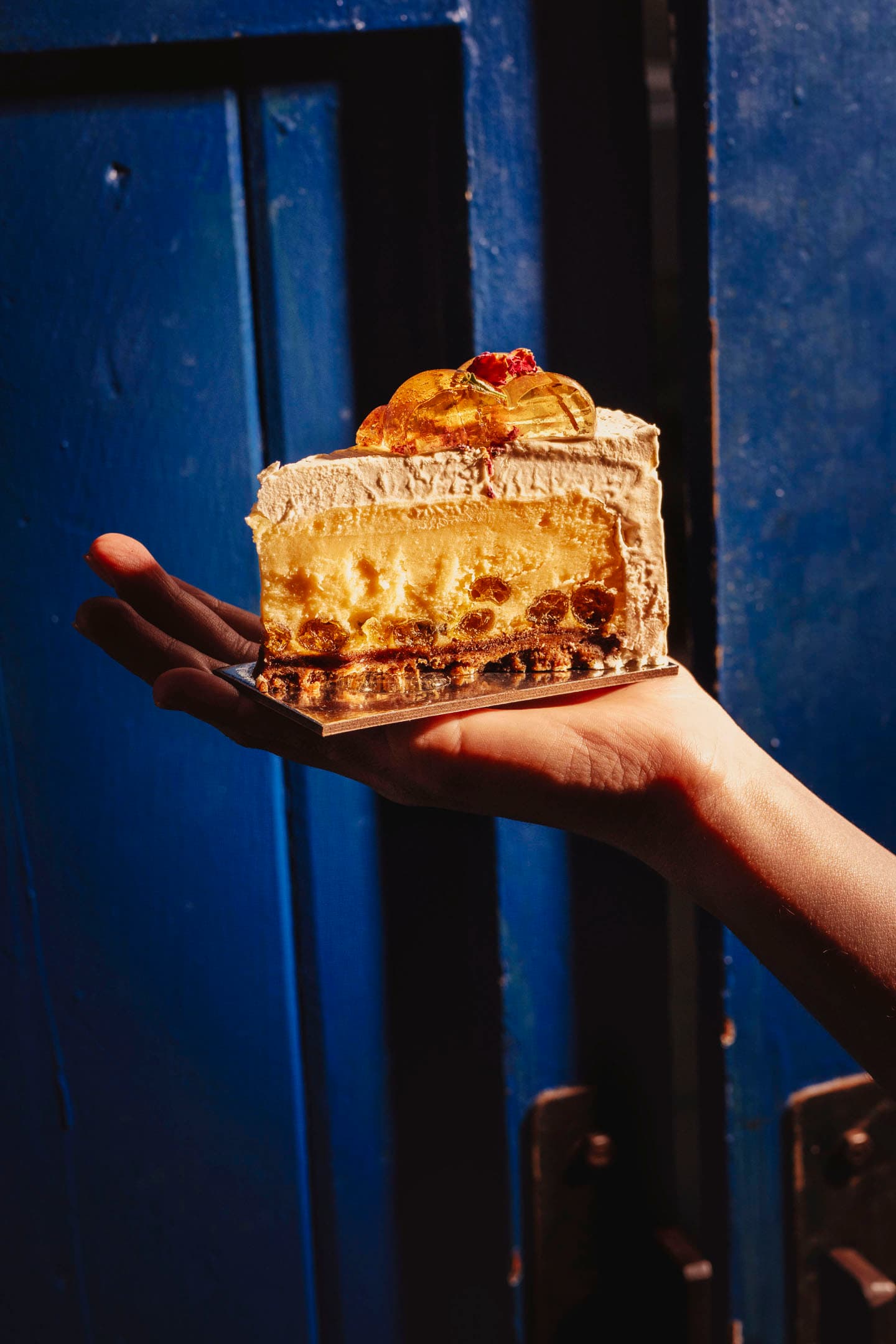 Handheld cake lifestyle photography for bakery campaign